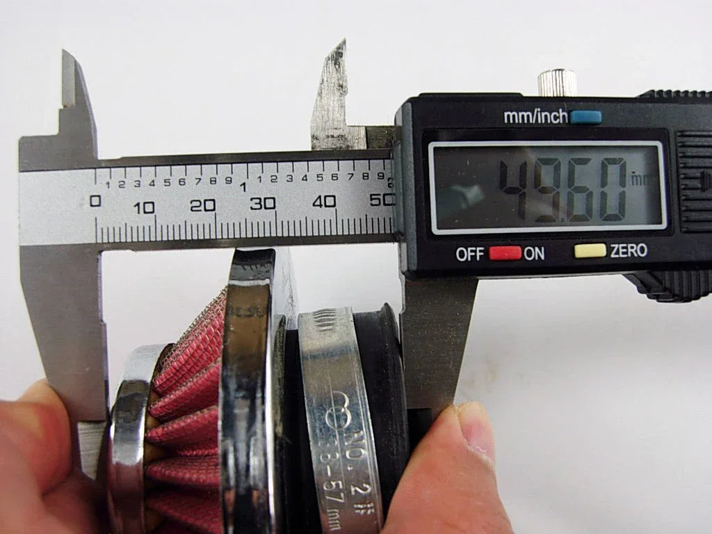 Digital caliper measuring diameter of red pleated air filter showing 49.60 mm