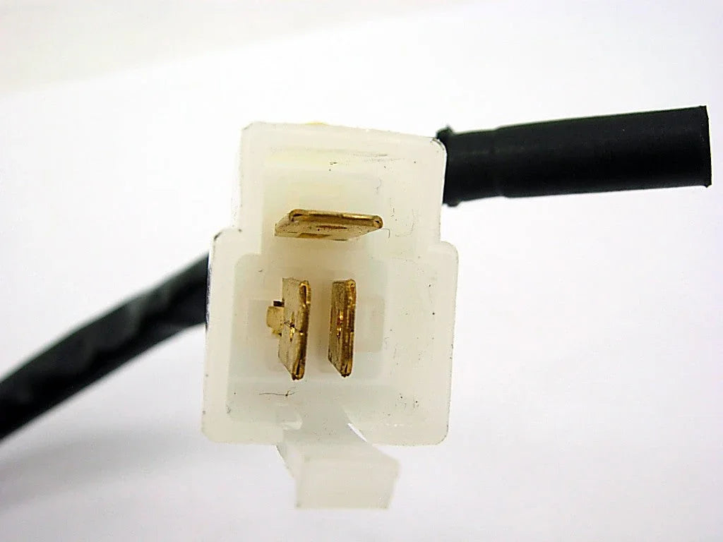 Close-up of white plastic electrical connector with three gold metal pins and black cable attached