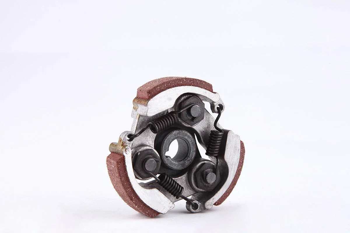 Close-up of a metal mechanical clutch assembly with springs and friction pads on white background