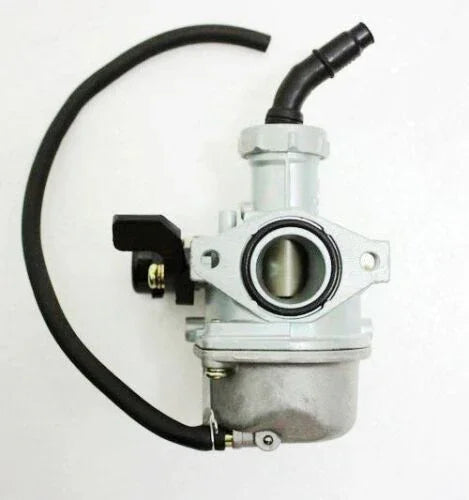 Silver motorcycle carburetor with black hose and fittings on white background