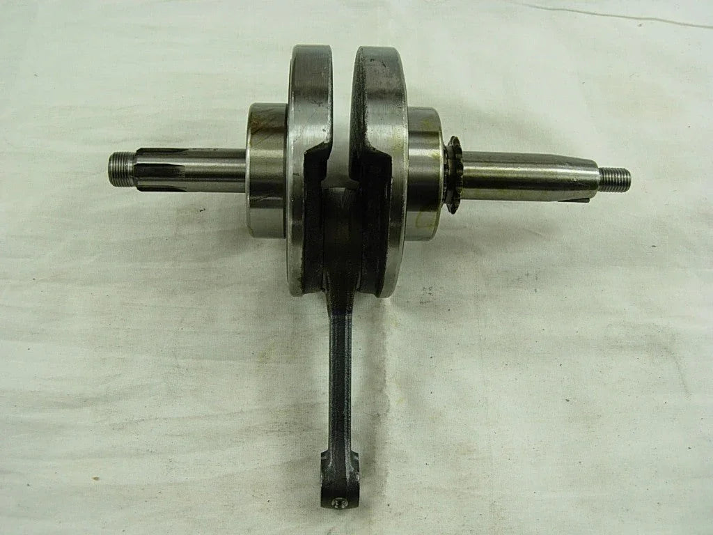 metal crankshaft with connecting rod on white fabric background