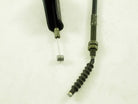 Close-up of metal cable with black plastic handle and threaded connector on white background