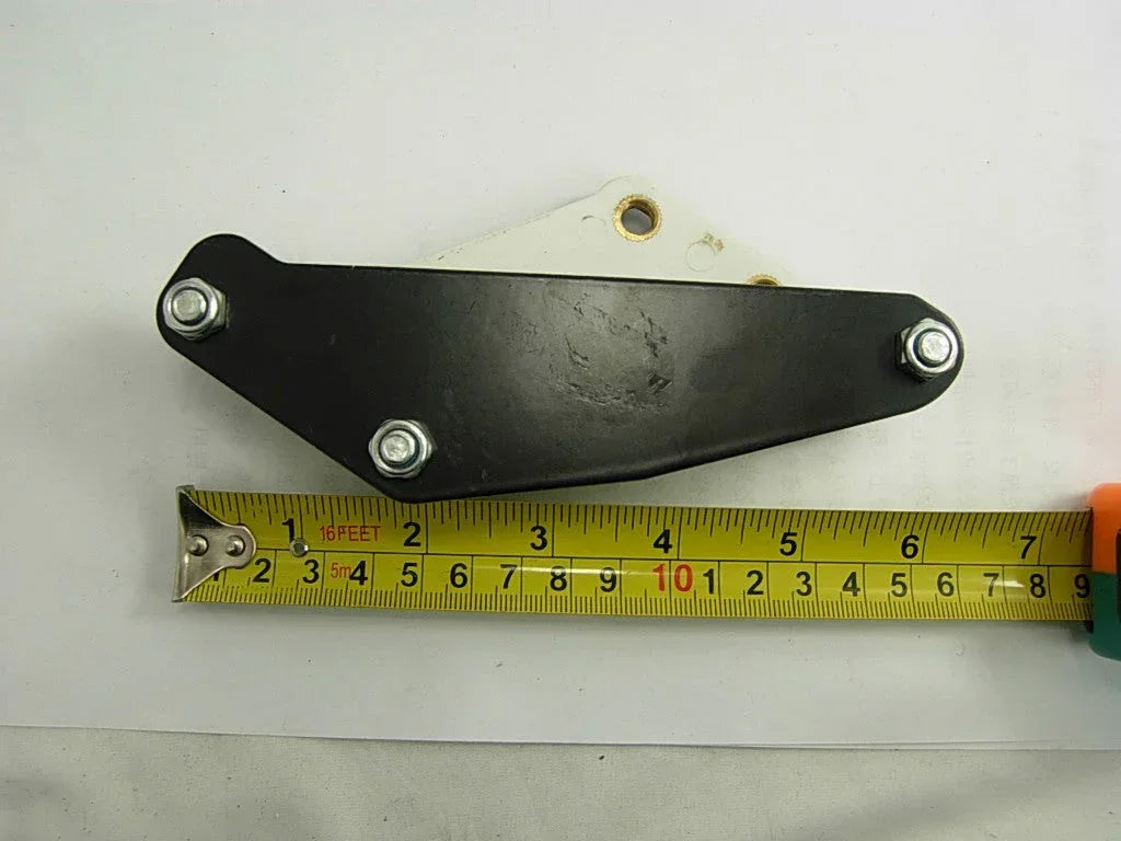 Alloy dirt bike chain guide part with three bolts, measured by tape on white background
