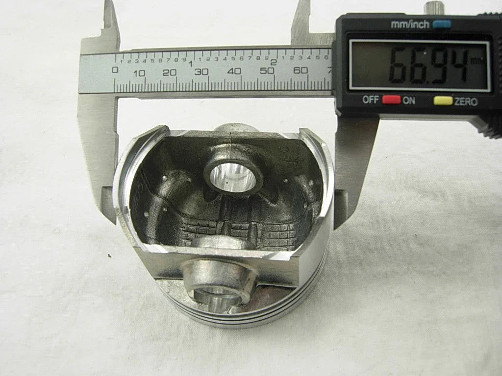 67mm piston for CG250cc dirt bike engine, ChinesePartsUSA, showing the metal piston with piston rings and top surface detail.