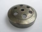 Round metal clutch drum with multiple circular cutouts on white background