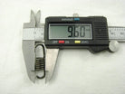 Digital caliper measuring a metal spring showing 9.60 mm length on white background