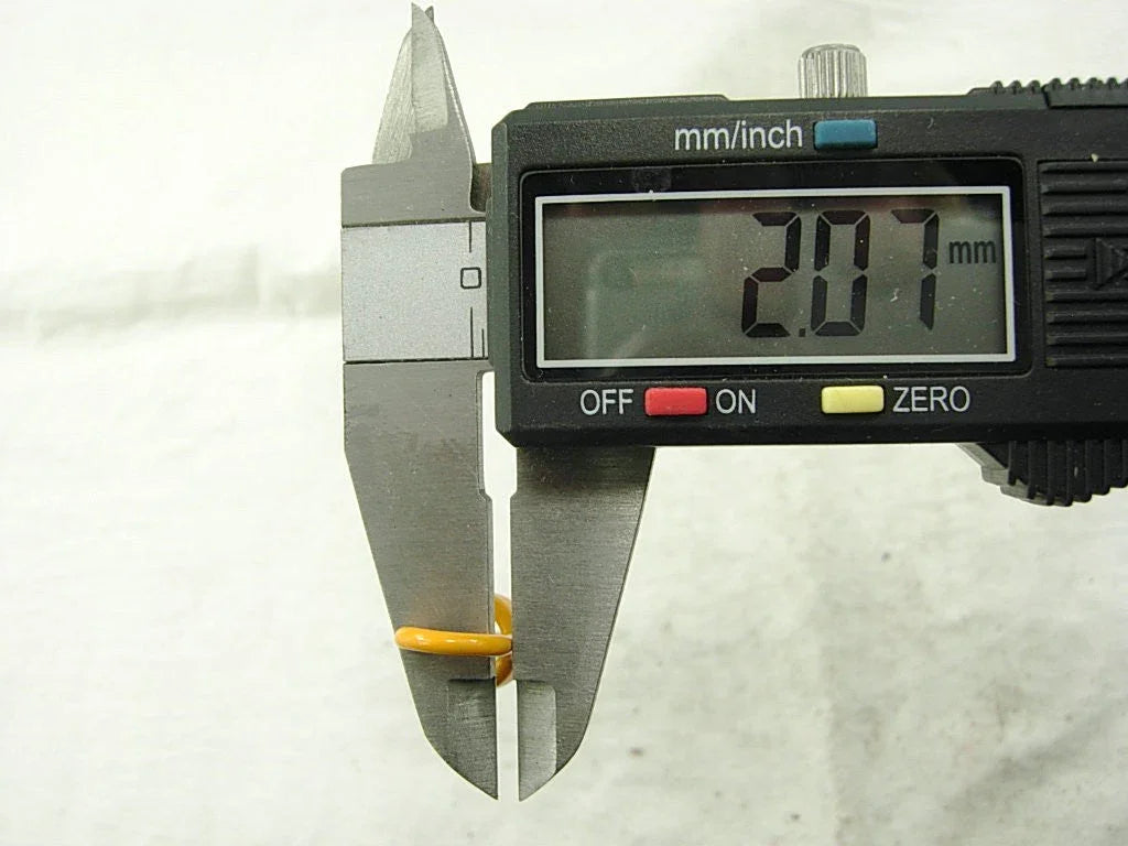 Digital caliper measuring an orange O-ring with a diameter of 2.07 mm on a white background