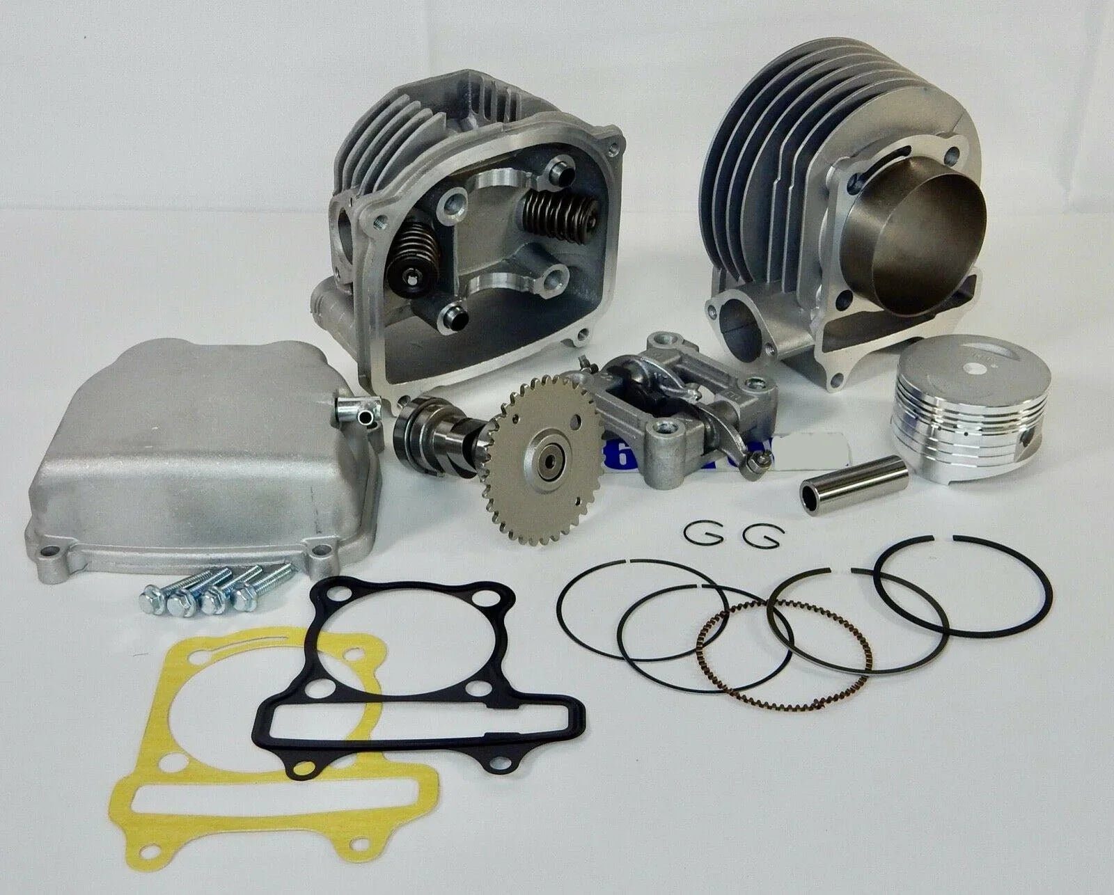 Motorcycle engine rebuild kit with cylinder, piston, camshaft, gaskets, and bolts on white background
