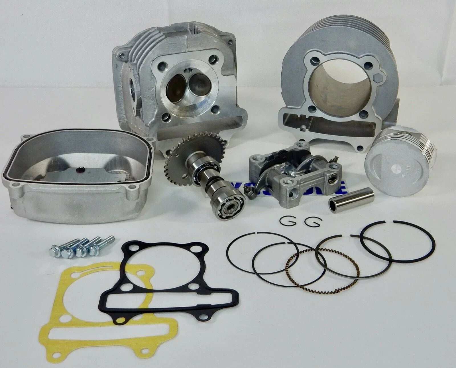 Motorcycle engine rebuild kit with cylinder head, piston, camshaft, gaskets, and rings on white background