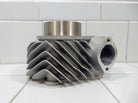 Silver metal engine cylinder head with cooling fins on white tiled surface