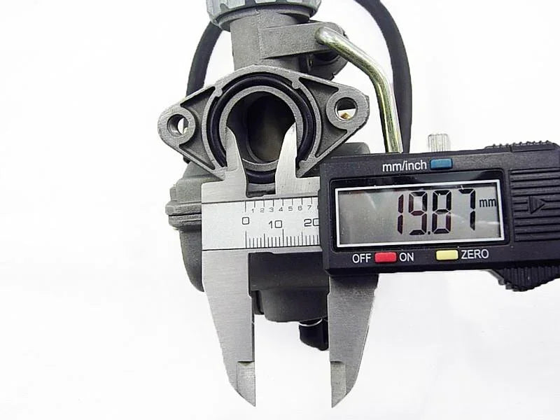 Digital caliper measuring 19.87mm opening on a 110cc PZ20 carburetor with metal choke