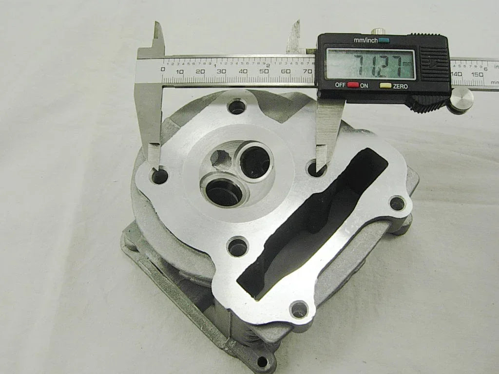 Aluminum engine cylinder head with digital caliper measuring 71.27mm, for motorcycles, ATVs, or go-karts