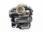 Metal motorcycle carburetor with spring, throttle valve, and attached rubber hoses on white background