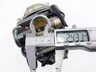 Digital caliper measuring 24.31 mm diameter of a mechanical carburetor part on white background