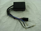 Black motorcycle CDI unit with attached wiring harness for Suzuki RM250 on white background