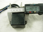 Black motorcycle CDI unit with attached wires measured by digital caliper at 42.18mm