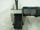 Digital caliper measuring black motorcycle CDI unit at 28.37mm on white background