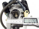 Close-up of a carburetor with digital caliper measuring 37.75 mm diameter on white background