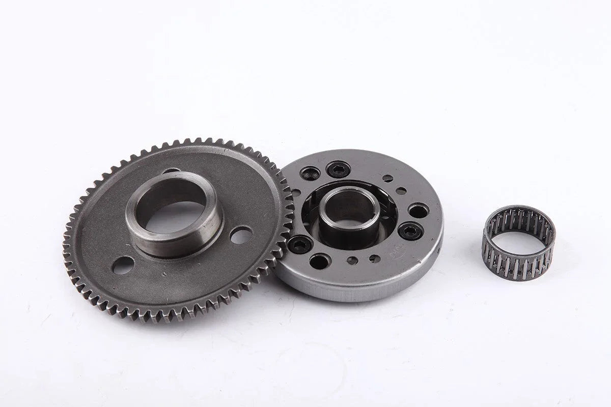 Metal gear set with a toothed gear, circular component with multiple holes, and needle bearing on white background