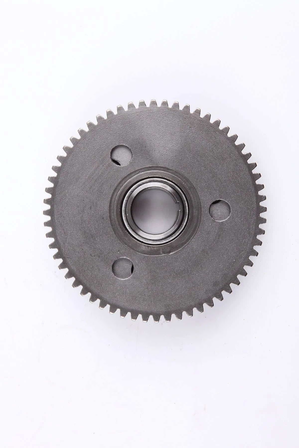 Metal circular gear with teeth and central bearing on white background