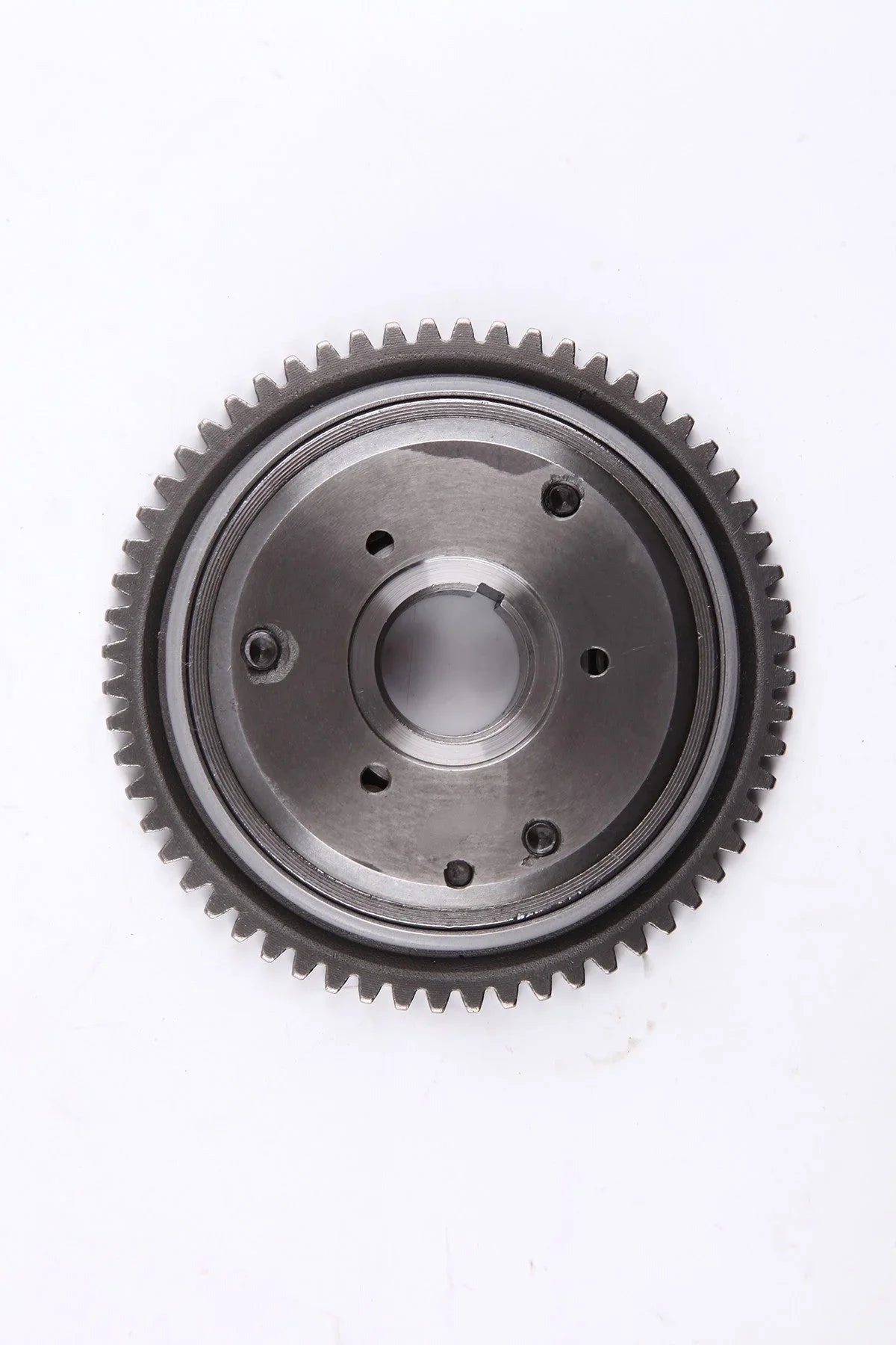 Metal gear wheel with teeth and central hole on white background