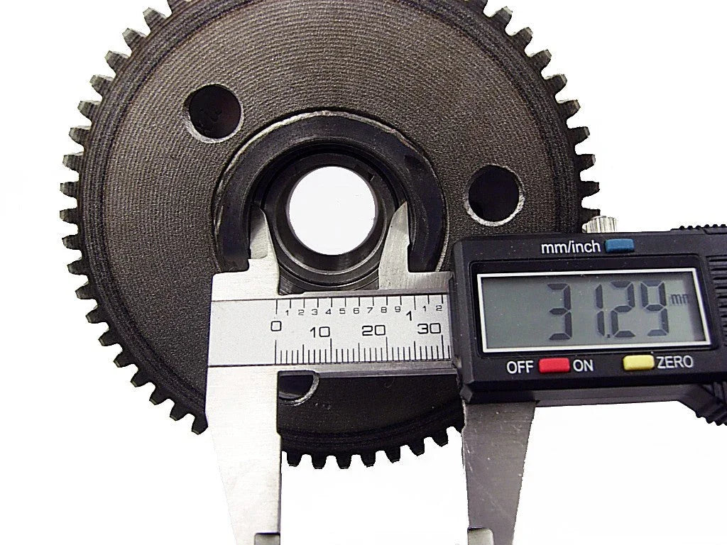 Digital caliper measuring the inner diameter of a black metal gear, showing 31.29 mm