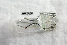 Clear glass motorcycle bulb with dual filaments and metal base for ATV, scooter, or dirt bike lighting