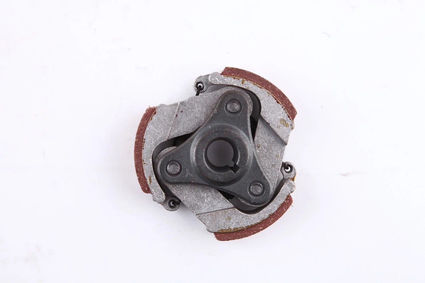 Close-up of a metal centrifugal clutch with three friction pads on white background