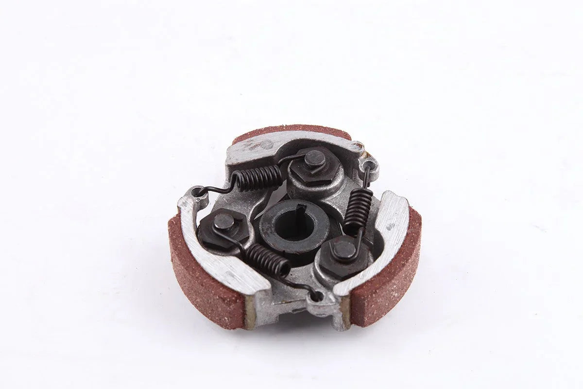 Close-up of a metal centrifugal clutch with springs and friction pads on a white background