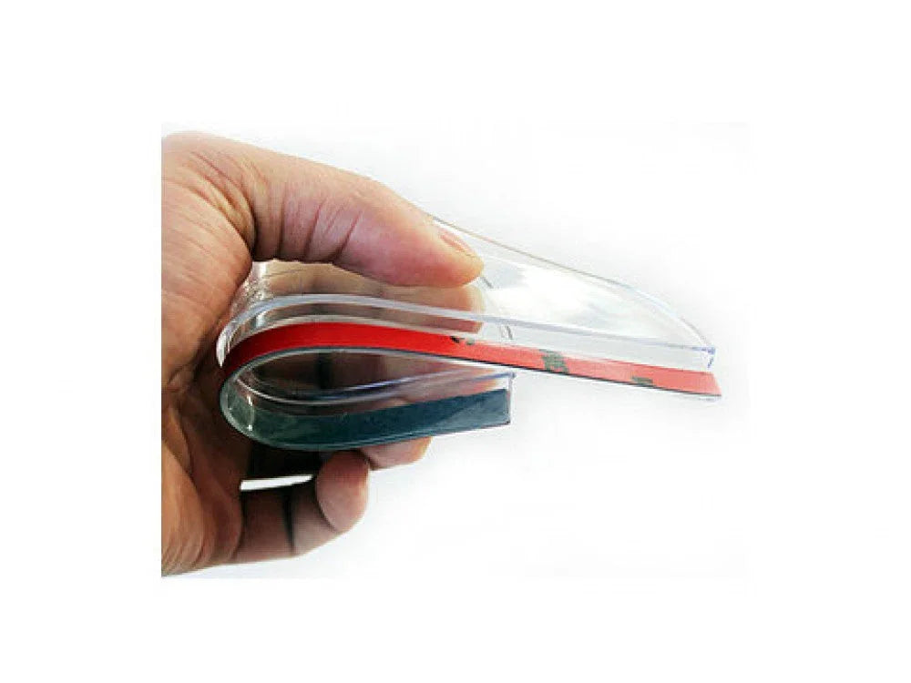 Hand holding a clear plastic rearview mirror rainproof blade cover with adhesive strip