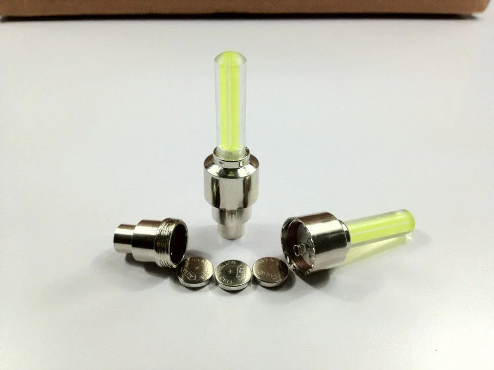 Set of two yellow LED valve stem lights for car, bike, and bicycle wheels with batteries
