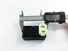 Digital caliper measuring small electrical connector for motorcycle or ATV parts, precise 65.05mm measurement