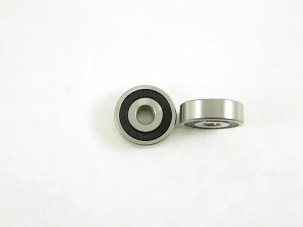 Close-up of a metal bearing showing its inner and outer rings, used in mechanical and automotive applications.
