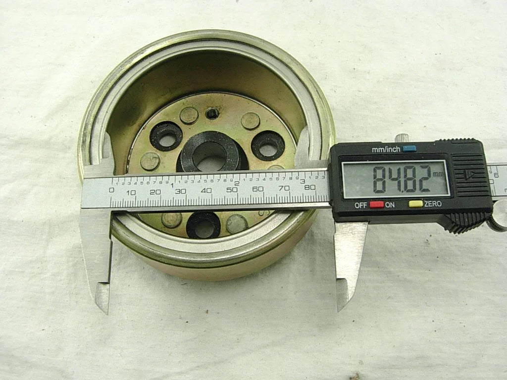 Dirt bike magneto stator rotor measured with digital caliper, 84.82mm diameter