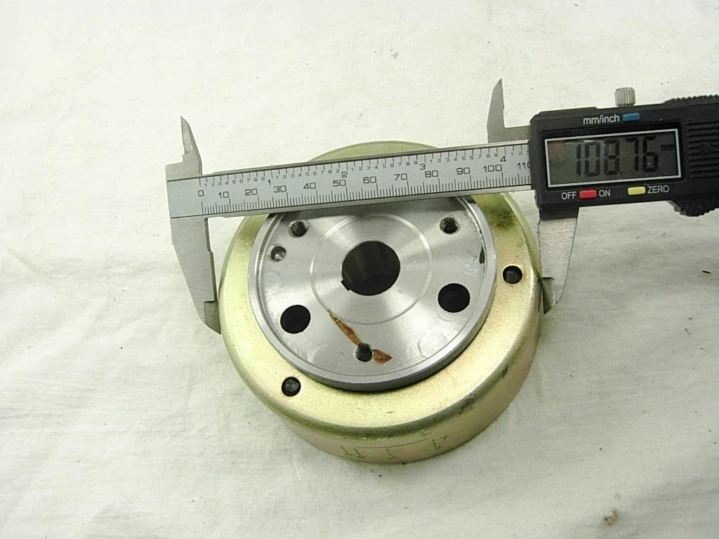 Two-coil magneto stator and rotor for 50cc, 110cc, and 125cc dirt bikes, durable motorcycle parts for engine performance.