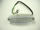 Clear oval LED motorcycle tail light with wiring harness and black cable on white background