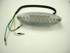 Oval LED motorcycle tail light with multiple clear lenses and three colored wires on white background