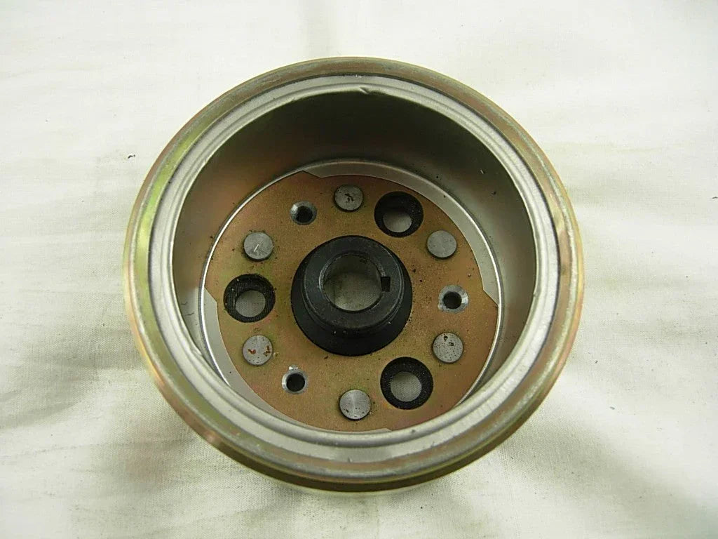 Four magneto rotors for 50cc, 110cc, and 125cc dirt bikes, compatible with various small motorcycle models.