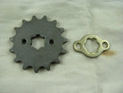Metal cogwheel and matching washer gear parts on a beige fabric background