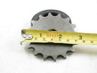 Close-up of a metal sprocket gear with a yellow measuring tape across it showing about 3 inches