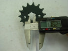 digital caliper measuring 17.62 mm inner diameter of black metal sprocket gear on white surface