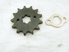 Metal sprocket gear and matching mounting plate on white fabric background