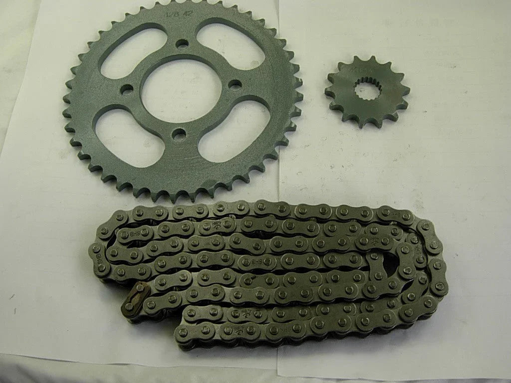 Metal motorcycle sprockets and chain on a white surface, black finish, mechanical parts