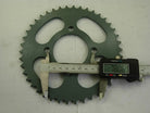 Digital caliper measuring the diameter of a green metal sprocket gear showing 78.06 mm