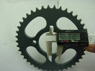 Digital caliper measuring a black 42-tooth bike sprocket thickness of 9.10 mm