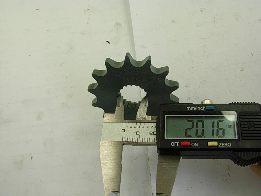 Digital caliper measuring 20.16 mm on a black steel gear with 12 teeth marked 428-14