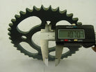 Digital caliper measuring 10.70 mm thickness of black metal sprocket gear