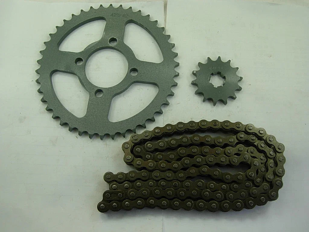 metal motorcycle sprockets and chain laid on white surface with visible teeth and holes