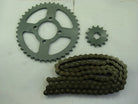 metal motorcycle sprockets and chain laid on white surface with visible teeth and holes