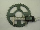 Digital caliper measuring 68.14 mm on green metal bike sprocket with 44 teeth